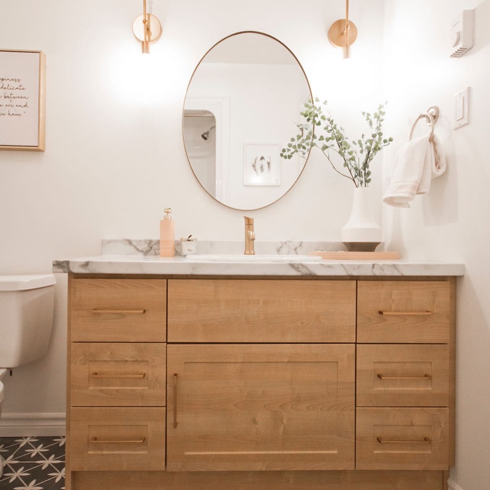 Thermofoil wood look vanity with laminate countertop and gold accents.